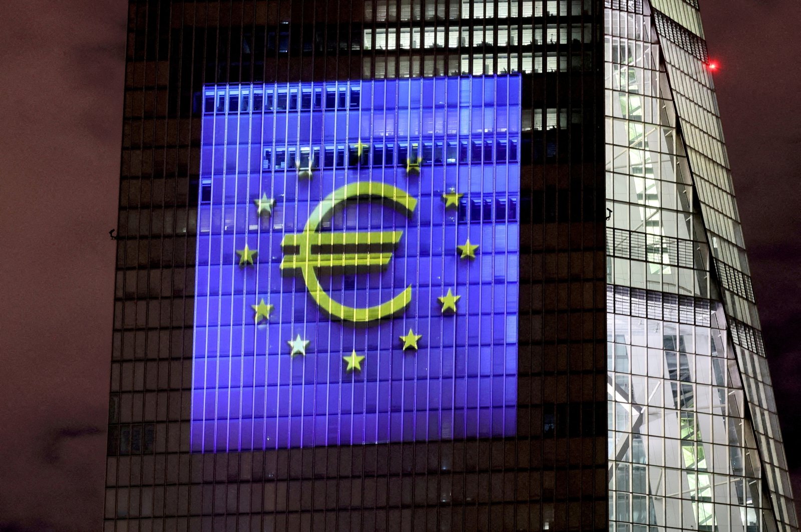 A symphony of light consisting of bars, lines and circles in blue and yellow, the colors of the European Union, illuminates the south facade of the ECB headquarters in Frankfurt, Germany, Dec. 30, 2021. (Reuters Photo)