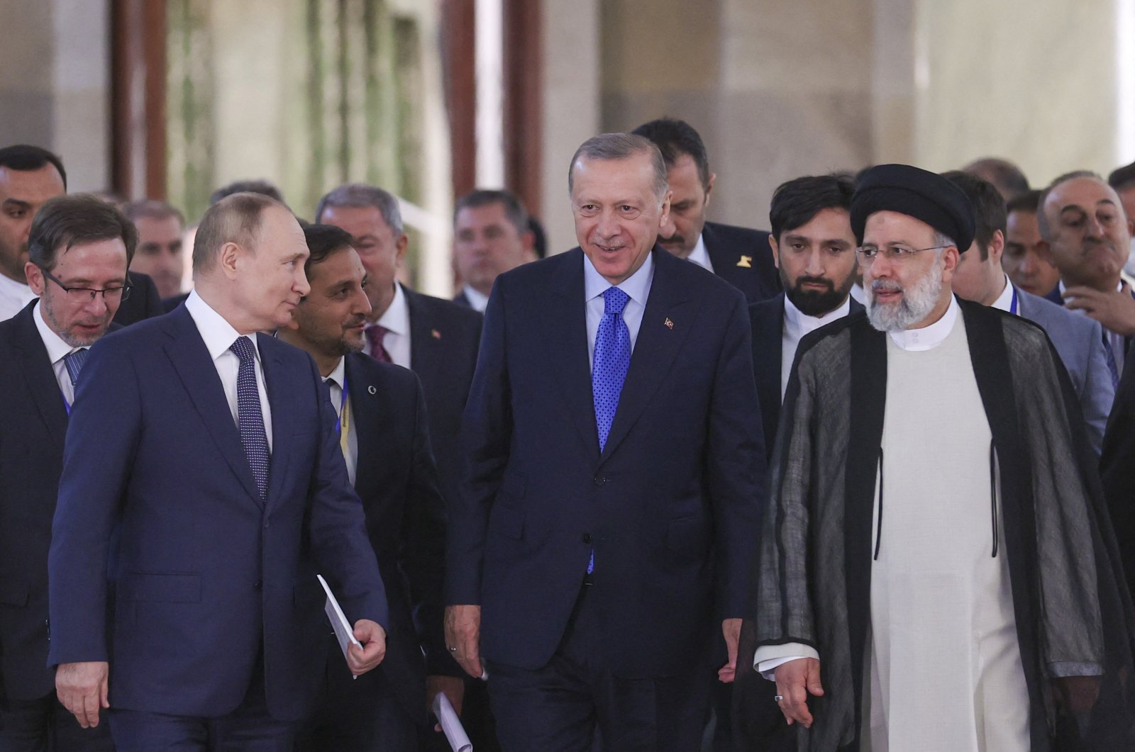 President Recep Tayyip Erdoğan (C), Iranian President Ebrahim Raisi (R) and Russian President Vladimir Putin (L) arriving for a joint news conference after the end of the Astana Trilateral Summit at the Tehran International Conference Hall in Tehran, Iran, July 19, 2022. (AFP Photo)