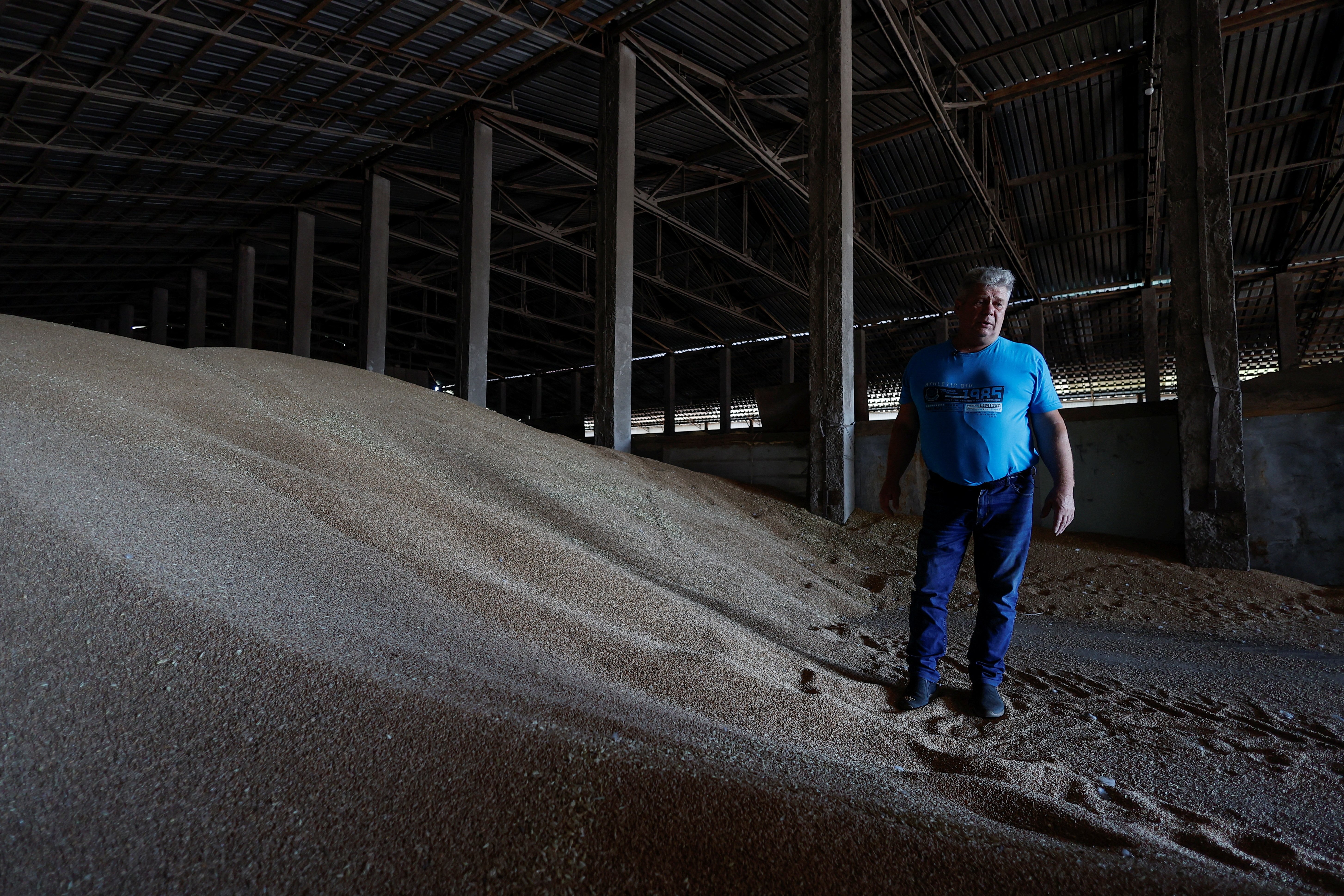 Ukrainian farmer Oleksandr Chubuk shows wheat grain inside a storage facility, as Russia&#039;s attack on Ukraine continues, in the village of Zhurivka, Ukraine, July 23, 2022. (REUTERS PHOTO)