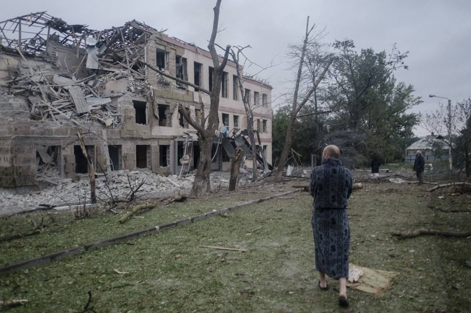 Locals stand in front of a damaged school after a missile strike hit the city of Kramatorsk, Donetsk region, eastern Ukraine, July 21, 2022. (EPA Photo)