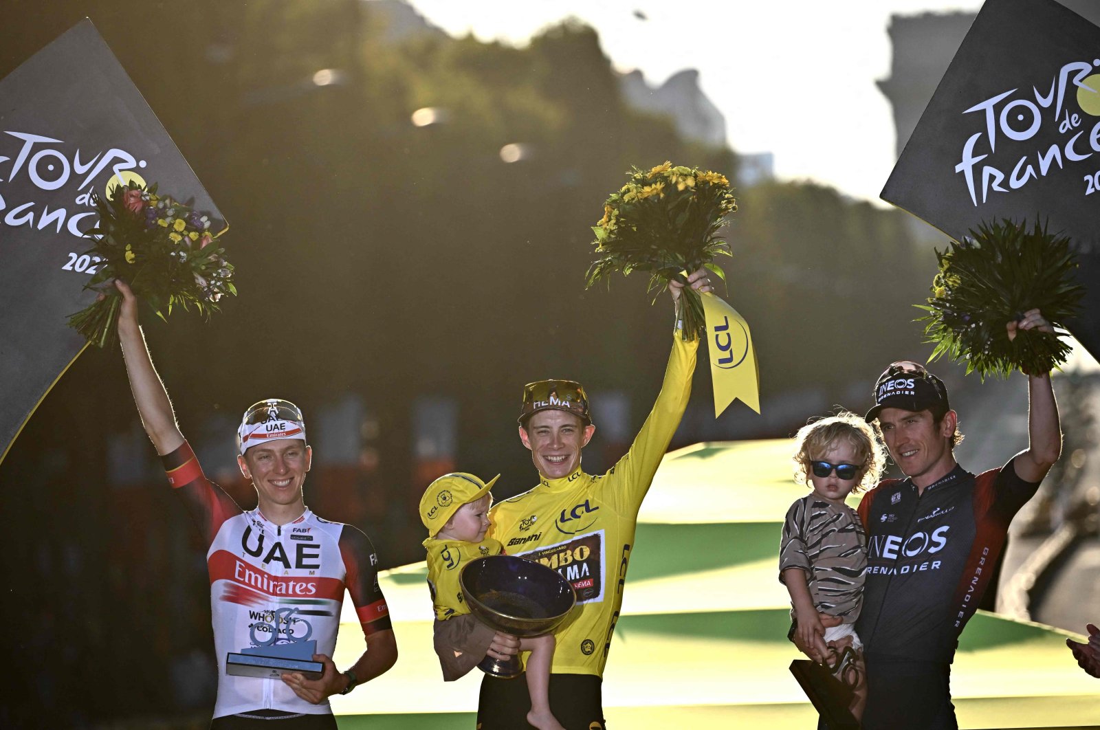 Jumbo-Visma&#039;s Danish rider Jonas Vingegaard (C) celebrates his overall victory on the podium after the 21st and final stage of the 109th edition of the Tour de France cycling race, July 24, 2022. (AFP Photo)
