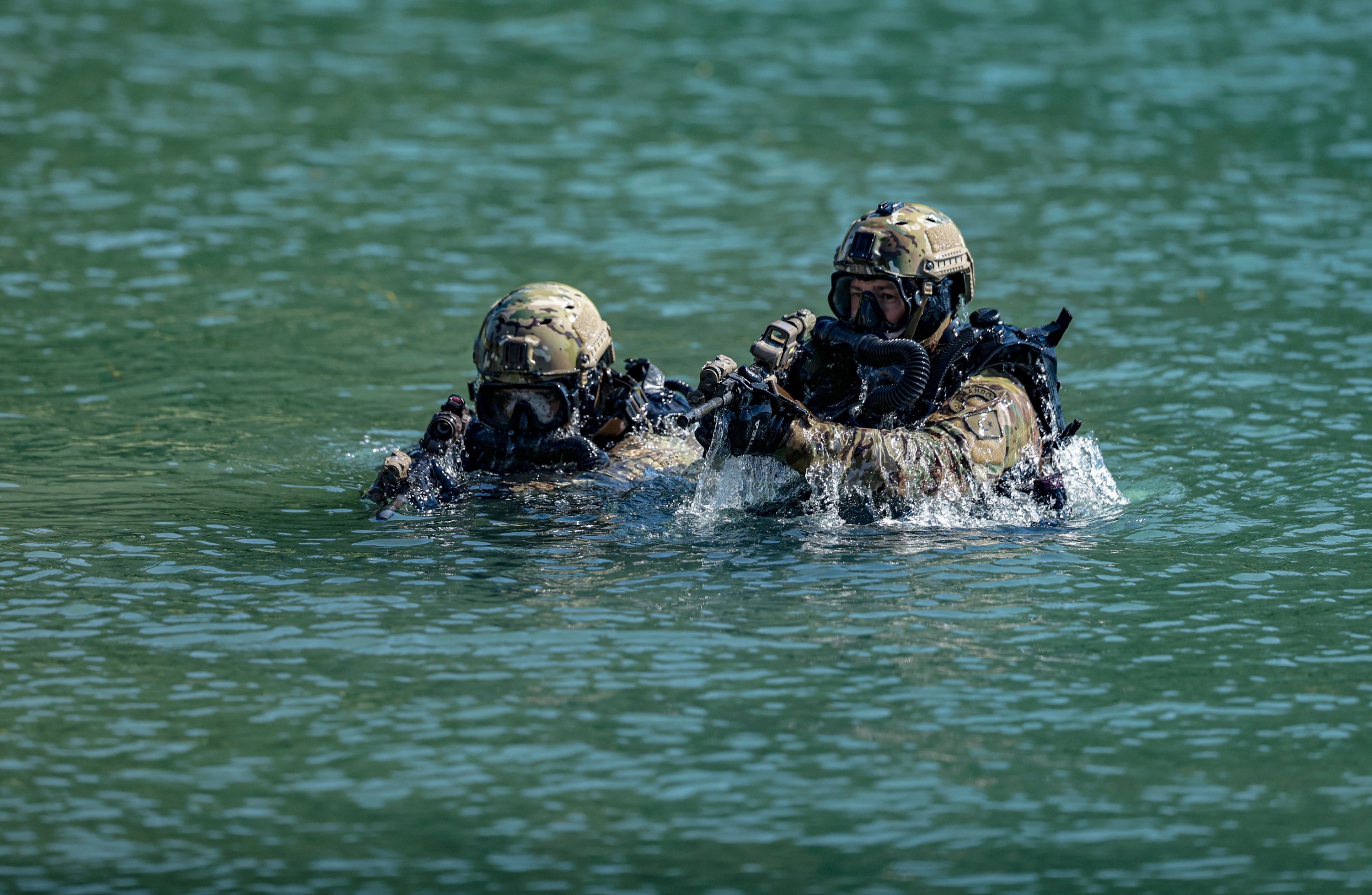 SAT commandos are seen training in the water.