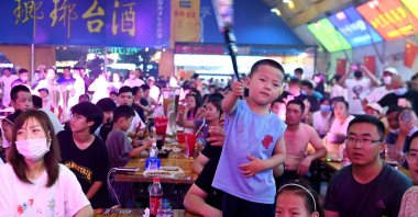 People enjoy drinks and food during the annual Qingdao Beer Festival in Qingdao, Shandong province, China, July 22, 2022. (AFP Photo)