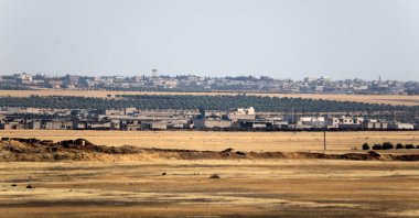 A picture taken on July 19, 2022, from a military position of Turkey-backed forces in the area of Jibrin, in Aleppo's eastern countryside, shows the YPG-controlled area of Tal Rifaat. (AFP)