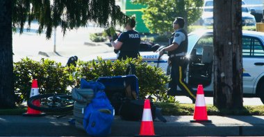 Police officers work at the site after authorities alerted residents of multiple shootings targeting transient victims in the Vancouver suburb of Langley, British Columbia, Canada, July 25, 2022. (Reuters Photo)