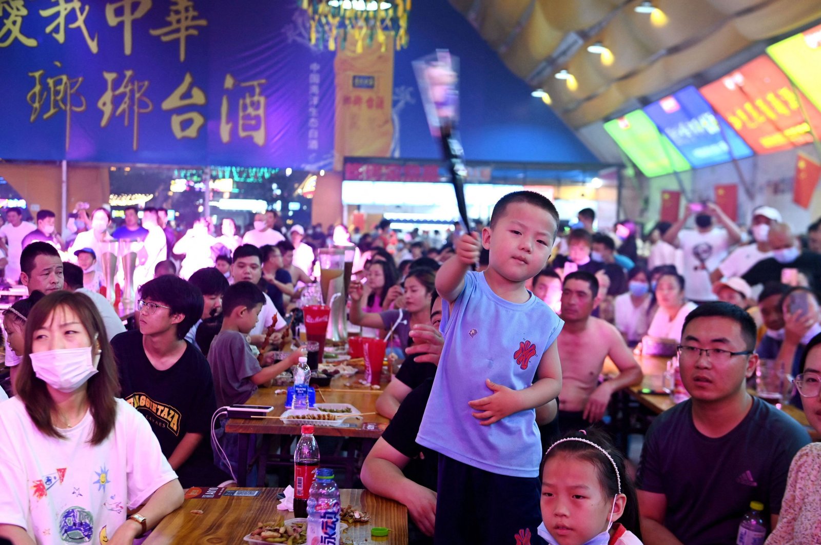 People enjoy drinks and food during the annual Qingdao Beer Festival in Qingdao, Shandong province, China, July 22, 2022. (AFP Photo)