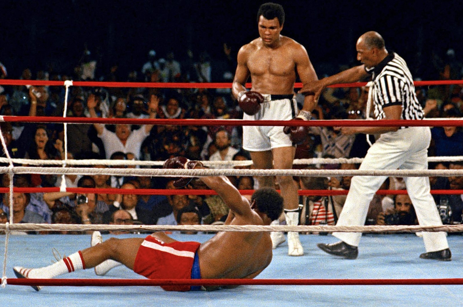 Muhammad Ali (C) in action against defending heavyweight champion George Foreman in the eighth round of their championship bout, Kinshasa, Zaire, Oct. 30, 1974. (AP Photo)