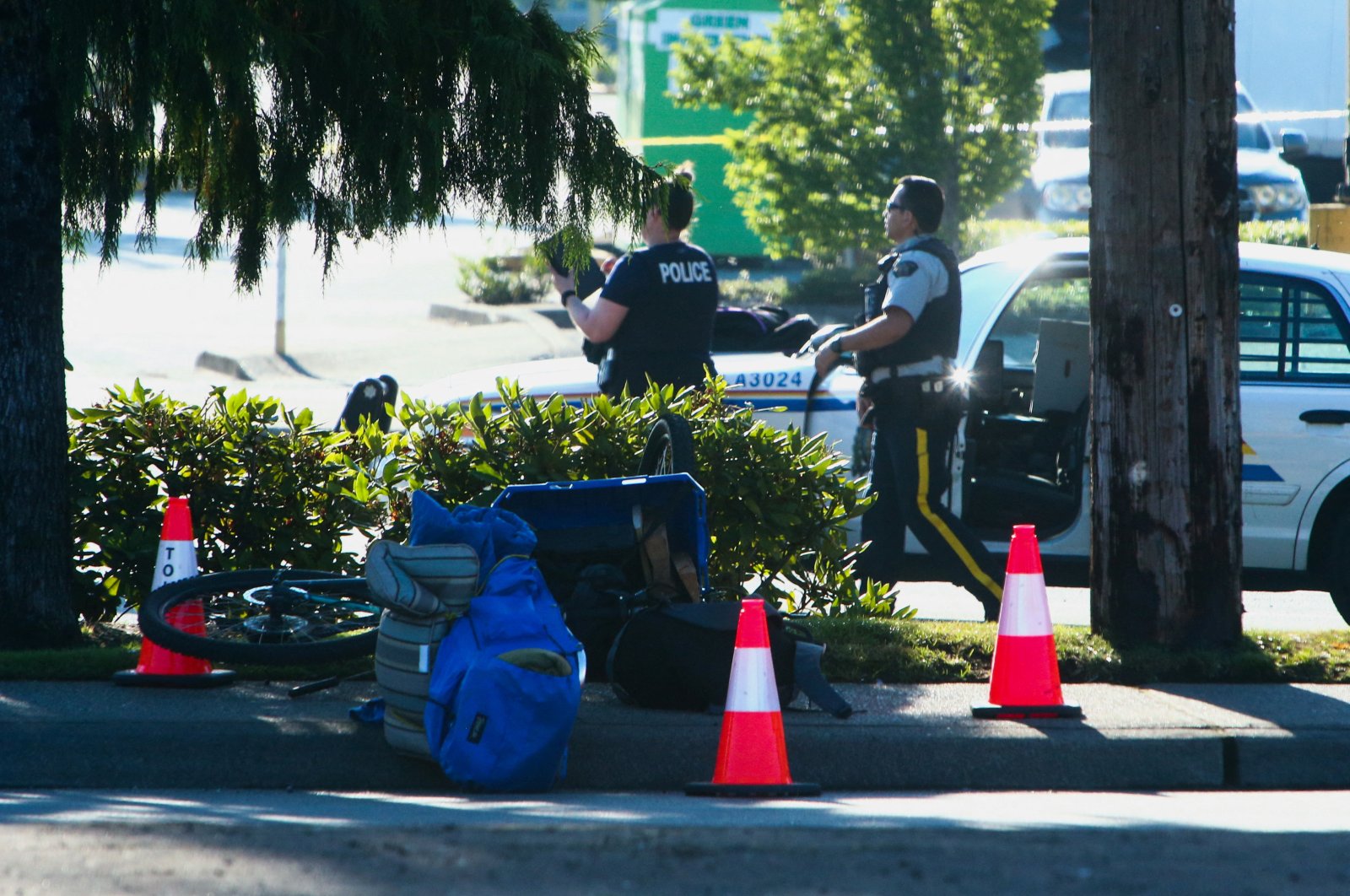 Police officers work at the site after authorities alerted residents of multiple shootings targeting transient victims in the Vancouver suburb of Langley, British Columbia, Canada, July 25, 2022. (Reuters Photo)