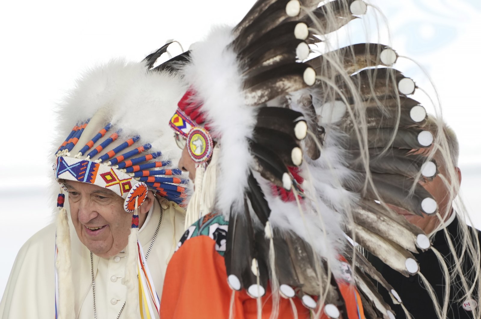 Pope Francis wears a traditional headdress he was given after his apology to Indigenous people for the Catholic Church&#039;s role in residential schools during a ceremony in Maskwacis, Alberta, Canada, July 25, 2022. (The Canadian Press via AP)