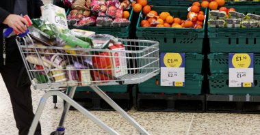 A person pushes a shopping cart inside a branch of a Tesco supermarket in London, Britain, Feb. 10, 2022. (Reuters Photo)