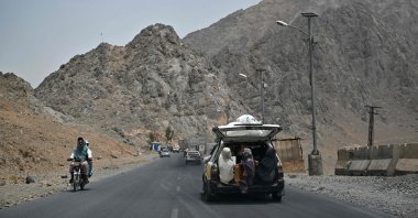 Burqa-clad women sit in the back of a vehicle leading to Kandahar city, Afghanistan, July 23, 2022. (AFP Photo)