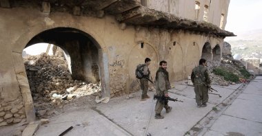 PKK terrorists walk in the damaged streets of Sinjar, Iraq, Jan. 29, 2015. (AP File Photo)
