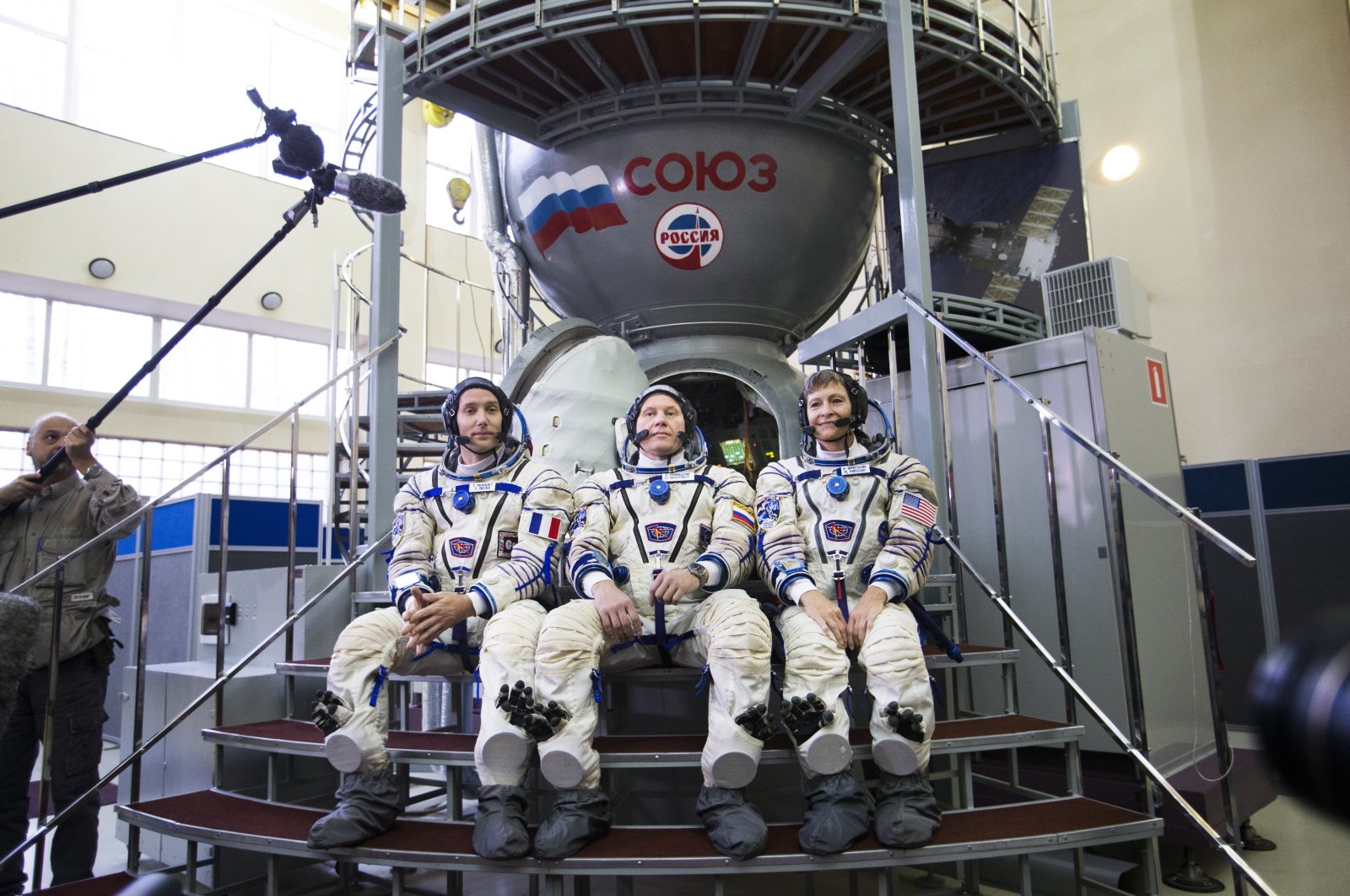 ESA French astronaut Thomas Pesquet, left, Russian cosmonaut Oleg Novitsky, center, and U.S. astronaut Peggy Annette Whitson pose for a photo before their final preflight practical examination in a mock-up of a Soyuz spacecraft at Russian Space Training Center in Star City, outside Moscow, Russia, Oct. 25, 2016. (AP File Photo)