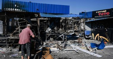 A man stands next to the damage caused to the central market in Sloviansk by a suspected missile attack, Ukraine, July 6, 2022. (AFP Photo)