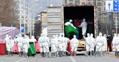 Workers in protective suits take part in the disinfection of Huanan seafood market, in Wuhan, Hubei province, China, March 4, 2020. (Reuters Photo)