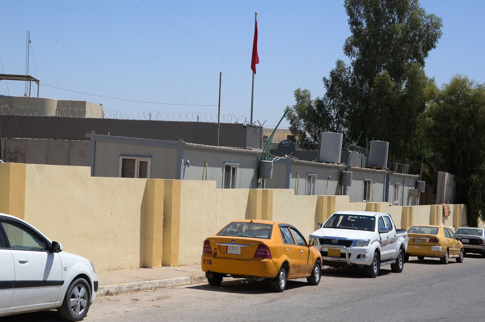 Vehicles park outside the Turkish consulate in a residential district of the northern Iraqi city of Mosul, July 27, 2022. (AFP Photo)