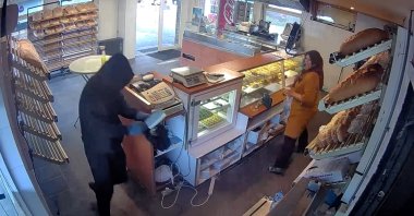 Latife Peker chasing a thief away with cleaning products in the bakery, Deventer, the Netherlands, July 26, 2022. (IHA Photo)