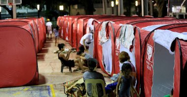 Residents rest at a temporary shelter set up on a basketball court in Bangued, in the province of Abra, the northern Philippines, July 27, 2022. (AFP Photo)