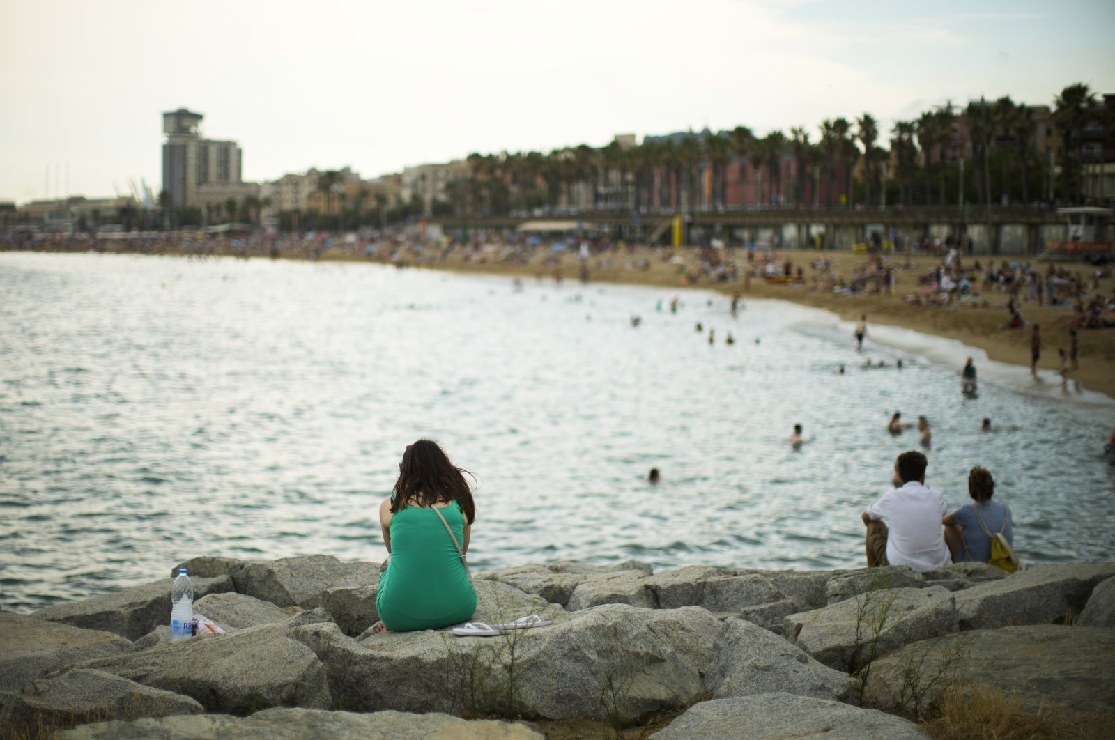 A woman sits by the beach in Barcelona, Spain, Thursday, July 28, 2022. Spain government&#039;s Equality Ministry launched a summer campaign Thursday encouraging women to reject &quot;stereotypes&quot; and &quot;aesthetical violence,&quot; a reference to social pressure some women feel to conform to beauty ideals. (AP Photo)