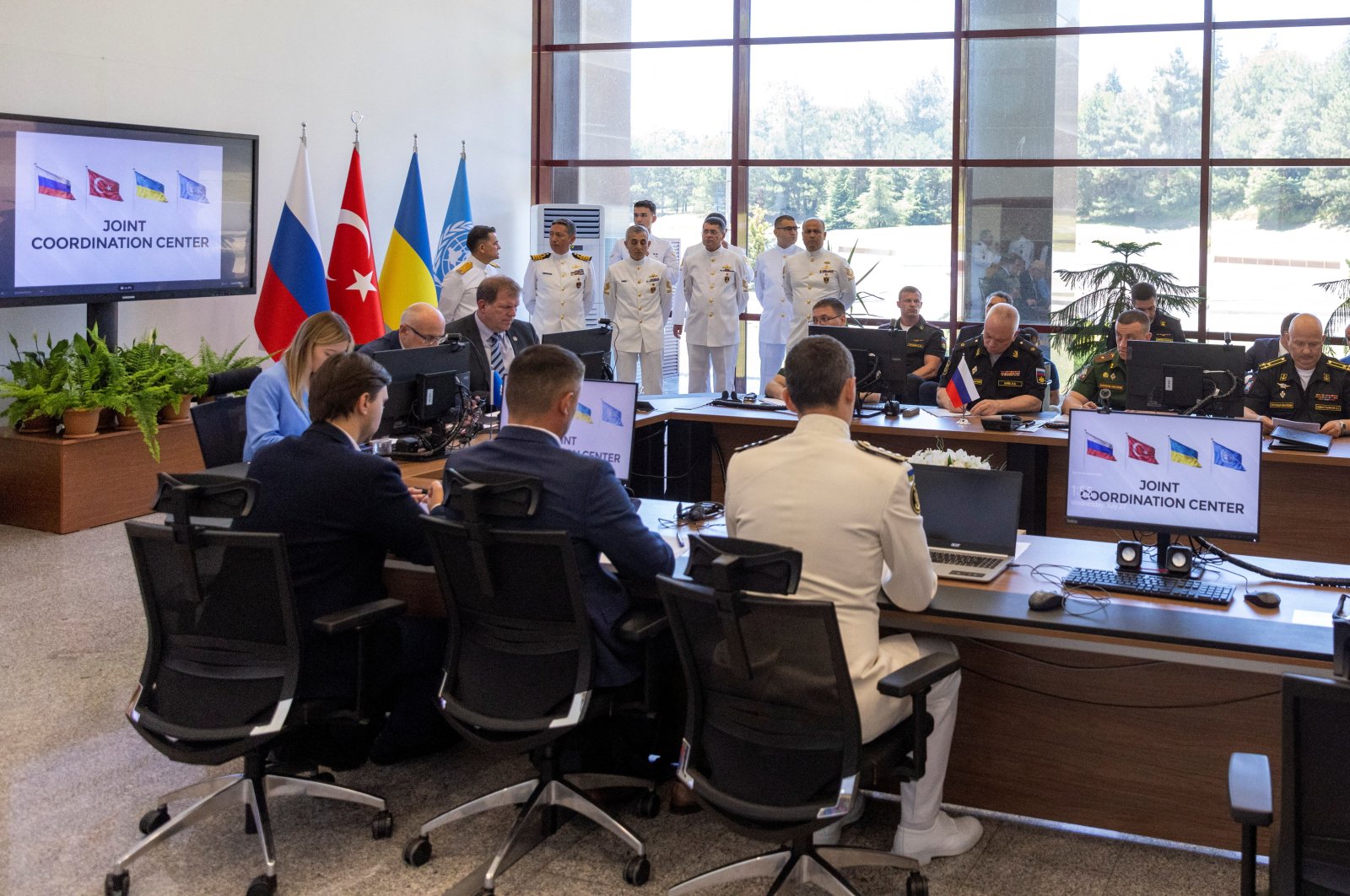 Military officers from Russia, Ukraine, Turkey and members of delegations from both countries and U.N. attend the opening ceremony of a joint coordination centre (JCC) that will oversee a U.N.-brokered deal to re-open Ukrainian grain exports in the Black Sea, in Istanbul, Turkey, July 27, 2022. REUTERS/Umit Bektas