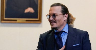 Actor Johnny Depp gestures to spectators in court after closing arguments during his defamation case against ex-wife Amber Heard at the Fairfax County Circuit Courthouse in Fairfax, Virginia, U.S., May 27, 2022. (Reuters Photo)