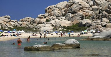 Tourists bathe on a white sand beach at the Lavezzi islands, close to Bonifacio on the French Mediterranean island of Corsica, July 10, 2022. (AFP Photo)