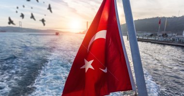 The Turkish flag waves from a ferry on the Bosporus in Istanbul, Turkey, July 15, 2022 (Shutterstock Photo)