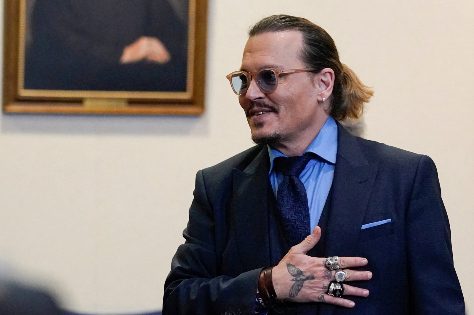 Actor Johnny Depp gestures to spectators in court after closing arguments during his defamation case against ex-wife Amber Heard at the Fairfax County Circuit Courthouse in Fairfax, Virginia, U.S., May 27, 2022. (Reuters Photo)