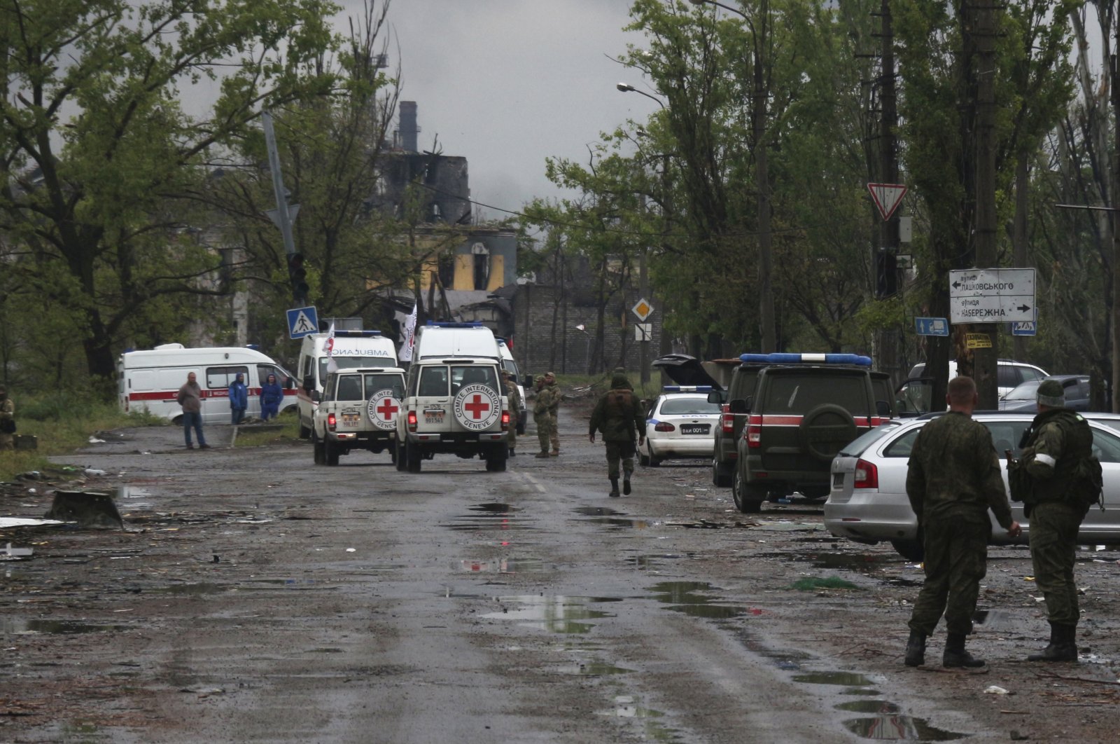 Red Cross staff drive by in their vehicles to the besieged Azovstal steel plant to observe the evacuation of Ukrainian servicemen in Mariupol, eastern Ukraine, May 18, 2022. (AP Photo)