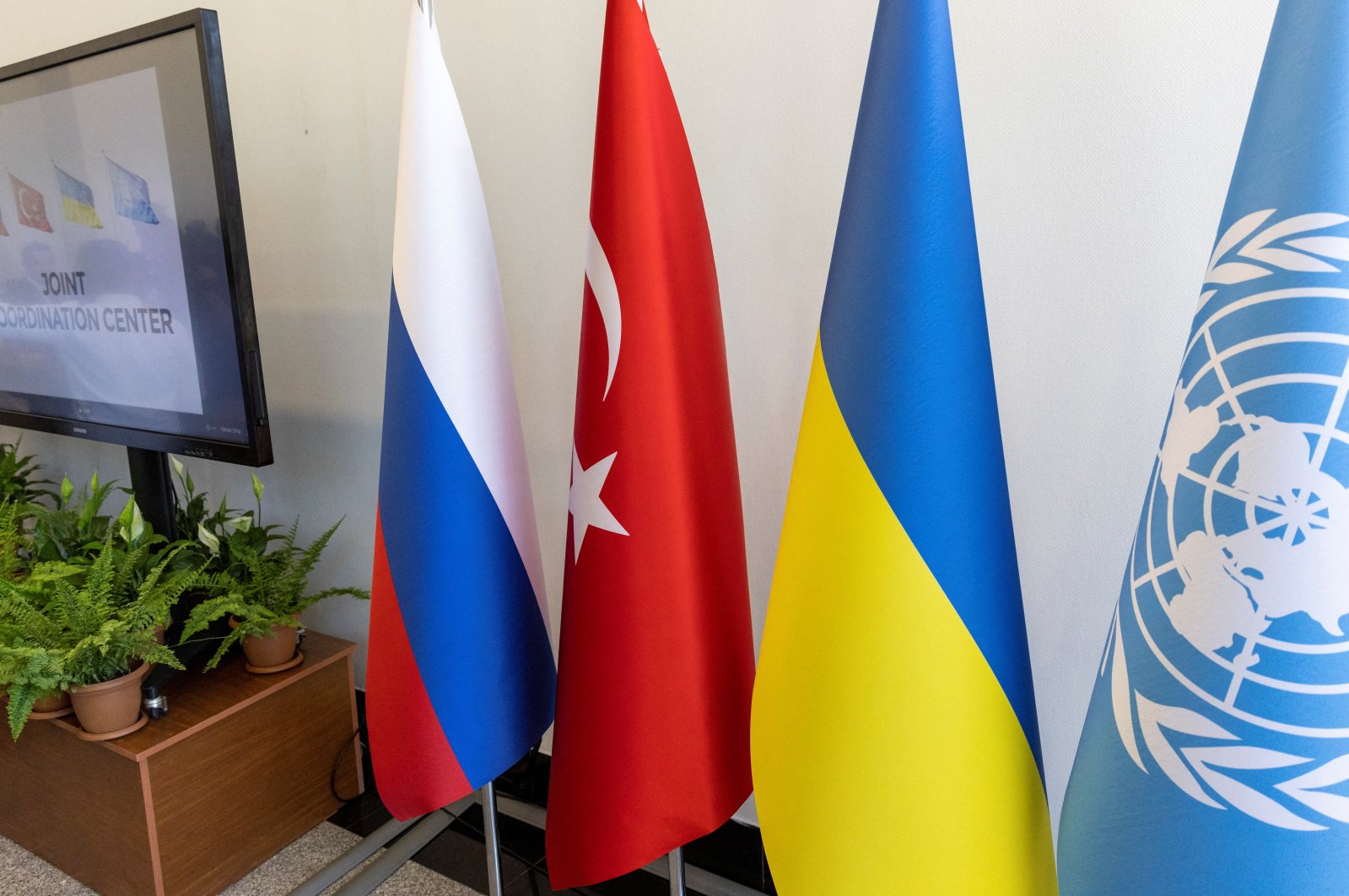 The flags of Russia, Ukraine, Turkey and the United Nations are seen during the opening ceremony of a joint coordination center (JCC) that will oversee a U.N.-brokered deal to reopen Ukrainian grain exports in the Black Sea, in Istanbul, Turkey, July 27, 2022. (REUTERS Photo)