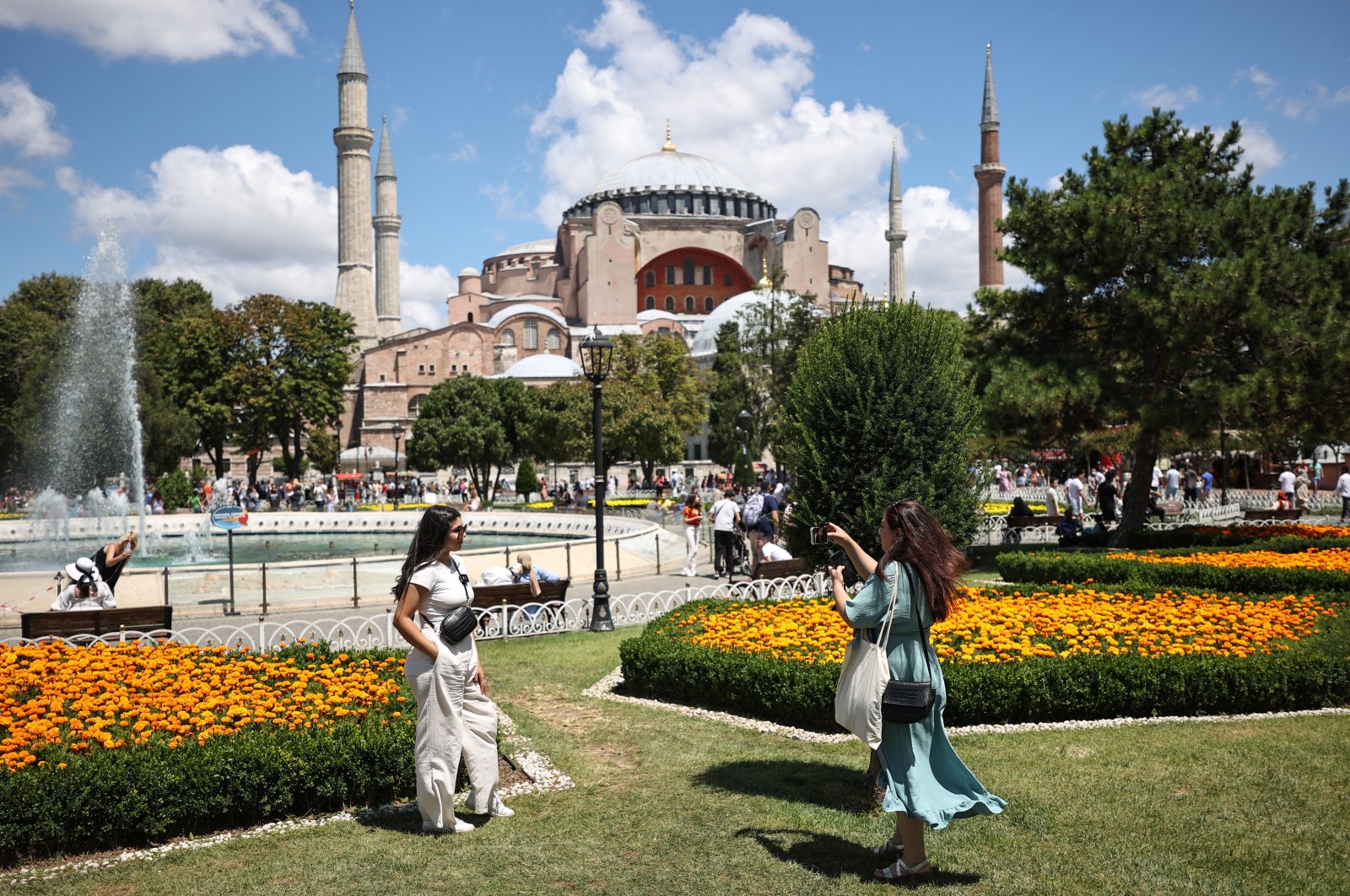 Tourists take a photo with the Hagia Sophia Grand Mosque in the background, in Istanbul, Turkey, July 19, 2022. (AA Photo)
