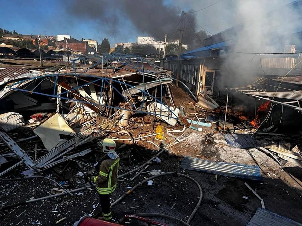 A firefighter works at a compound of a market destroyed by a Russian missile strike, in Bakhmut, Donetsk region, Ukraine, July 30, 2022. (Press service of the State Emergency Service of Ukraine via Reuters)