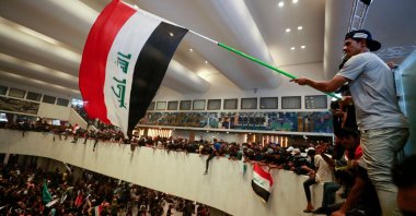 Protestors supporting Muqtada al-Sadr wave the Iraqi flag inside Iraq&#039;s parliament in the capital Baghdad, Iraq, July 30, 2022. (AFP Photo)