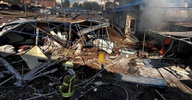 A firefighter works at a compound of a market destroyed by a Russian missile strike, in Bakhmut, Donetsk region, Ukraine, July 30, 2022. (Press service of the State Emergency Service of Ukraine via Reuters)