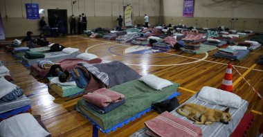 Homeless people rest with their animals in a shelter during low temperatures in Canoas, Brazil, July 26, 2022. (Reuters Photo)