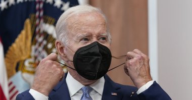 U.S. President Joe Biden removes his face mask as he arrives to speak about the economy during a meeting with CEOs in the South Court Auditorium on the White House complex in Washington, July 28, 2022. (AP Photo)