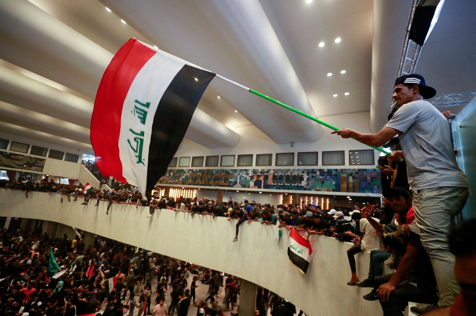 Protestors supporting Muqtada al-Sadr wave the Iraqi flag inside Iraq&#039;s parliament in the capital Baghdad, Iraq, July 30, 2022. (AFP Photo)