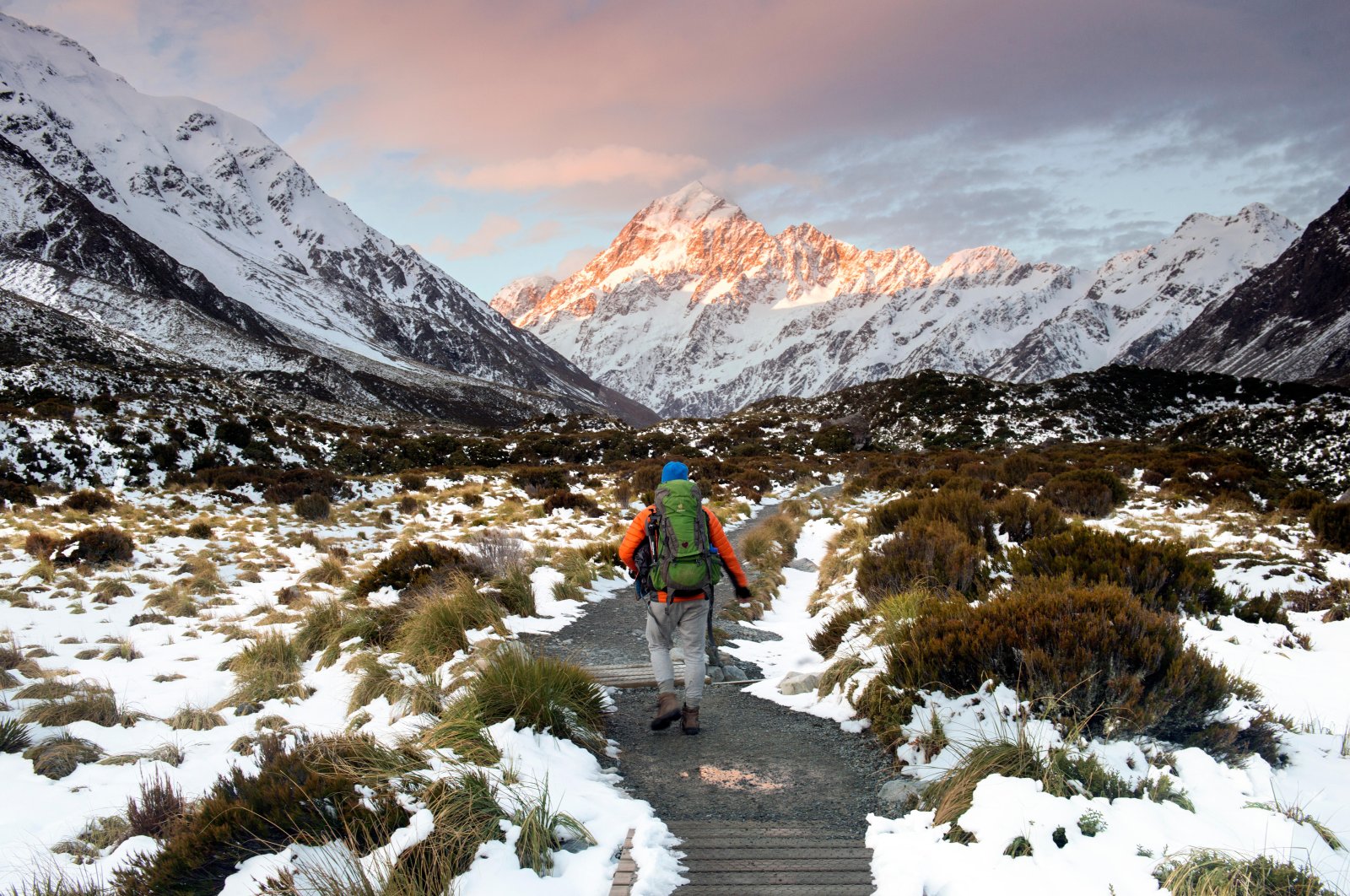 A hiker walks toward Mount Cook at dusk, New Zealand, Oct. 13, 2018. (Alamy Photo via Reuters)
