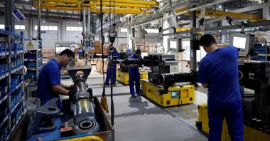 Employees work on the production line of vehicle components at a factory of German engineering group Voith in Shanghai, China, July 21, 2022. (Reuters Photo)