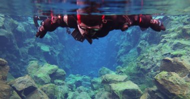 A snorkeller observes the fissure underwater in Thingvellir, Iceland, July 26, 2022. (Thomas Gov via AFP)