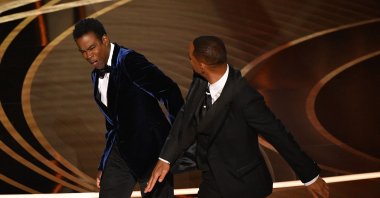 Will Smith (R) slaps Chris Rock onstage during the 94th Oscars at the Dolby Theater in Hollywood, California, U.S., March 27, 2022. (AFP Photo)