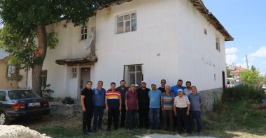 Villagers pose outside the house where Boris Johnson's ancestors were born, in Çankırı, north-central Turkey, July 31, 2022. (AA PHOTO)