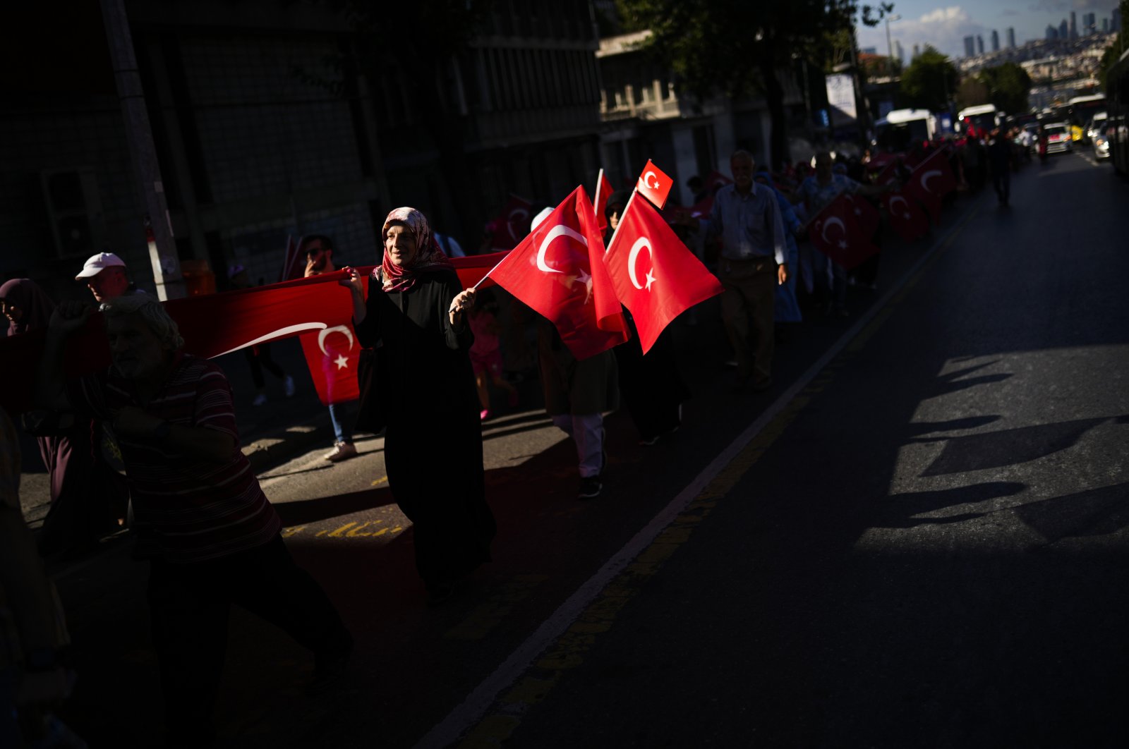 People wave Turkish flags as they rally to honor the victims of the July 15, 2016 failed coup attempt, in Istanbul, Turkey, July 15, 2022. (AP Photo)