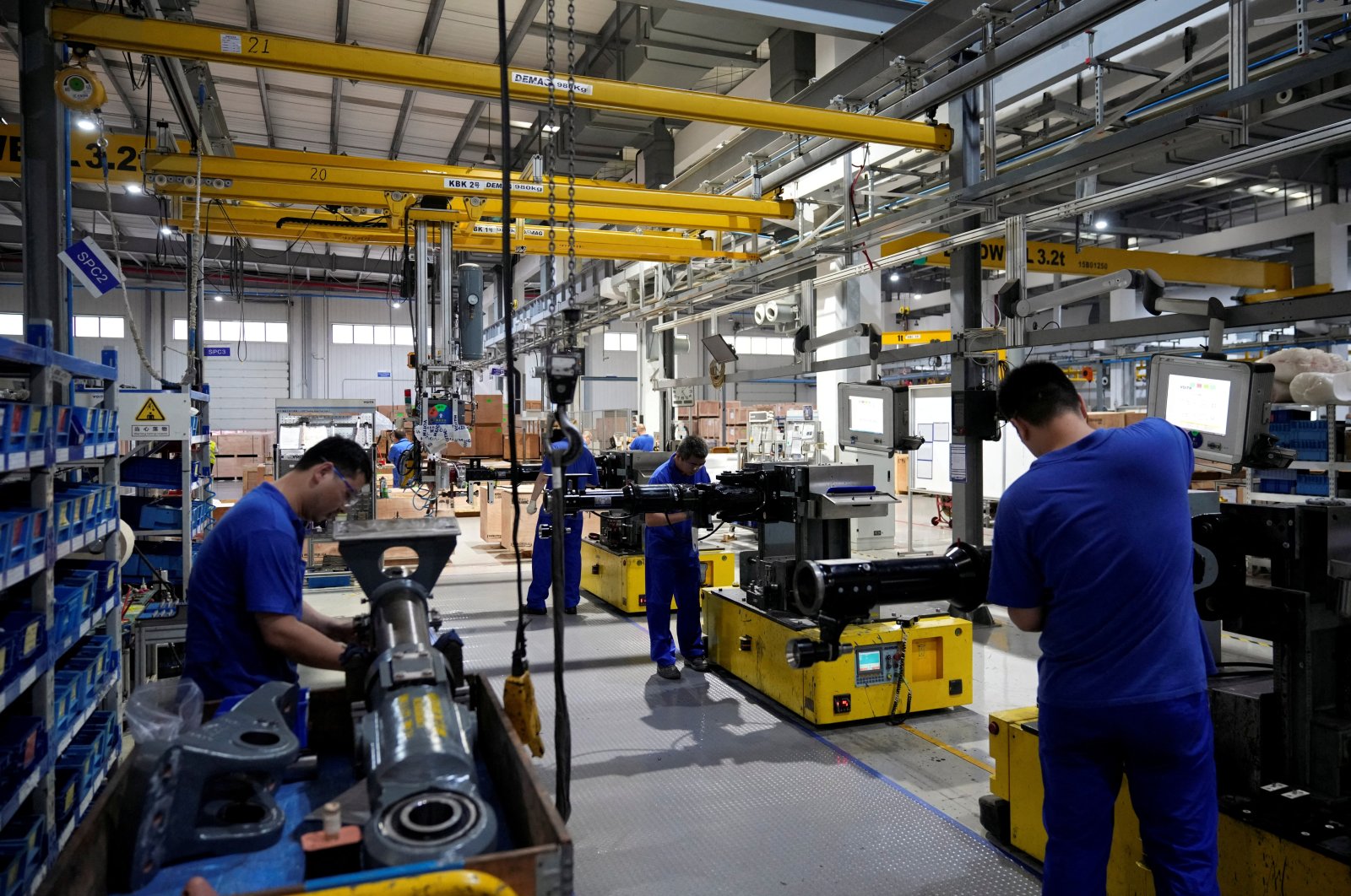 Employees work on the production line of vehicle components at a factory of German engineering group Voith in Shanghai, China, July 21, 2022. (Reuters Photo)