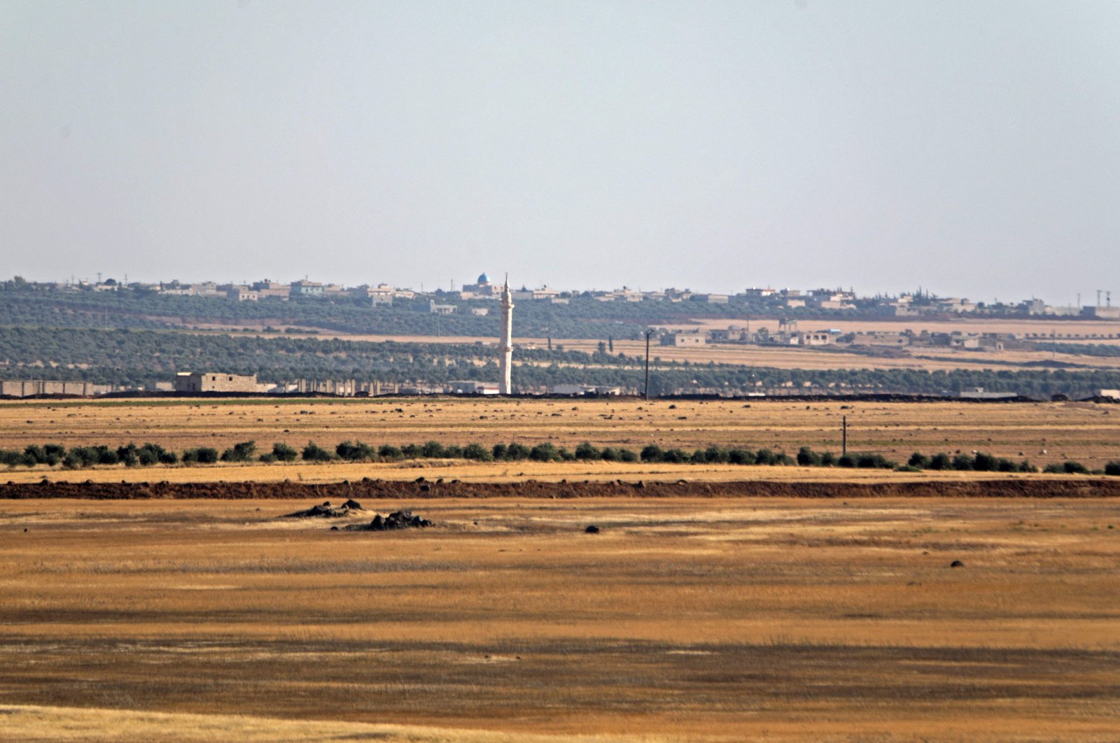 A picture taken on July 19, 2022, from a military position of Turkey-backed forces in the area of Jibrin, in Aleppo&#039;s eastern countryside, shows the YPG-controlled area of Tal Rifaat. (AFP)