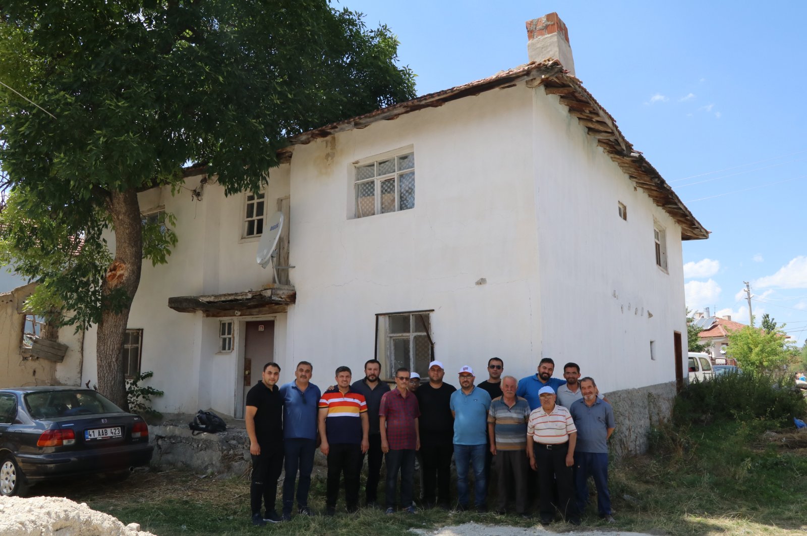 Villagers pose outside the house where Boris Johnson&#039;s ancestors were born, in Çankırı, north-central Turkey, July 31, 2022. (AA PHOTO)