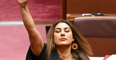 Australia Greens Senator for Victoria, Lidia Thorpe raises her arm during her swearing-in ceremony in the Senate chamber at Parliament House in Canberra,  Australia, Aug. 1, 2022. (AFP Photo)