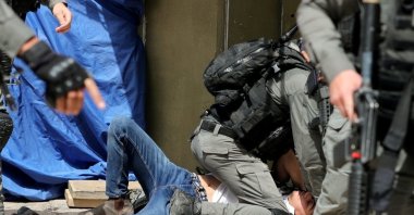 Israeli police detain a Palestinian during clashes at the compound that houses Al-Aqsa Mosque, in the Old City, East Jerusalem, occupied Palestine, May 10, 2021. (Reuters File Photo)