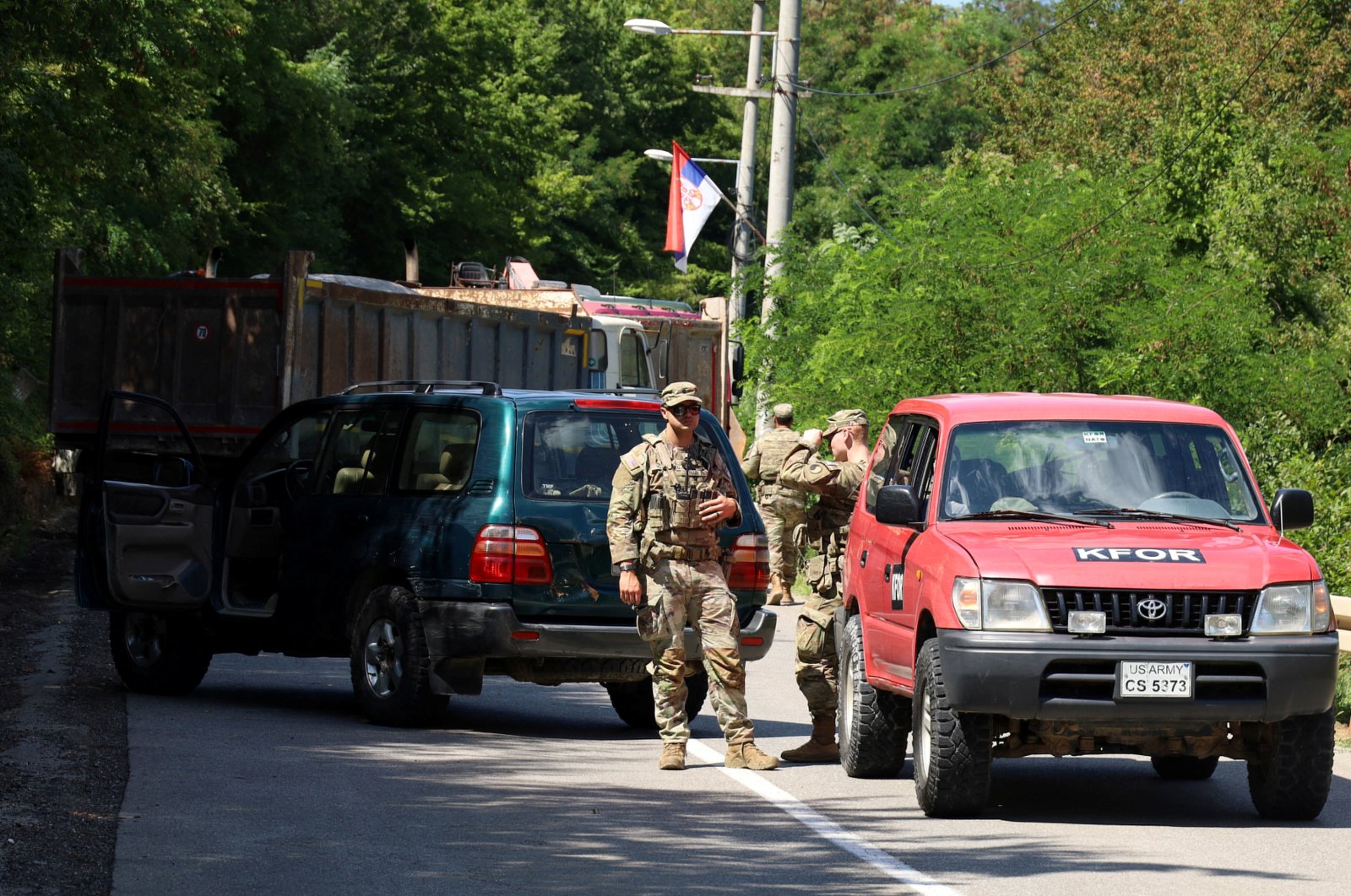 U.S. troops part of KFOR are seen as trucks block a road in Zupce, Kosovo, Aug. 1, 2022. (Reuters Photo)