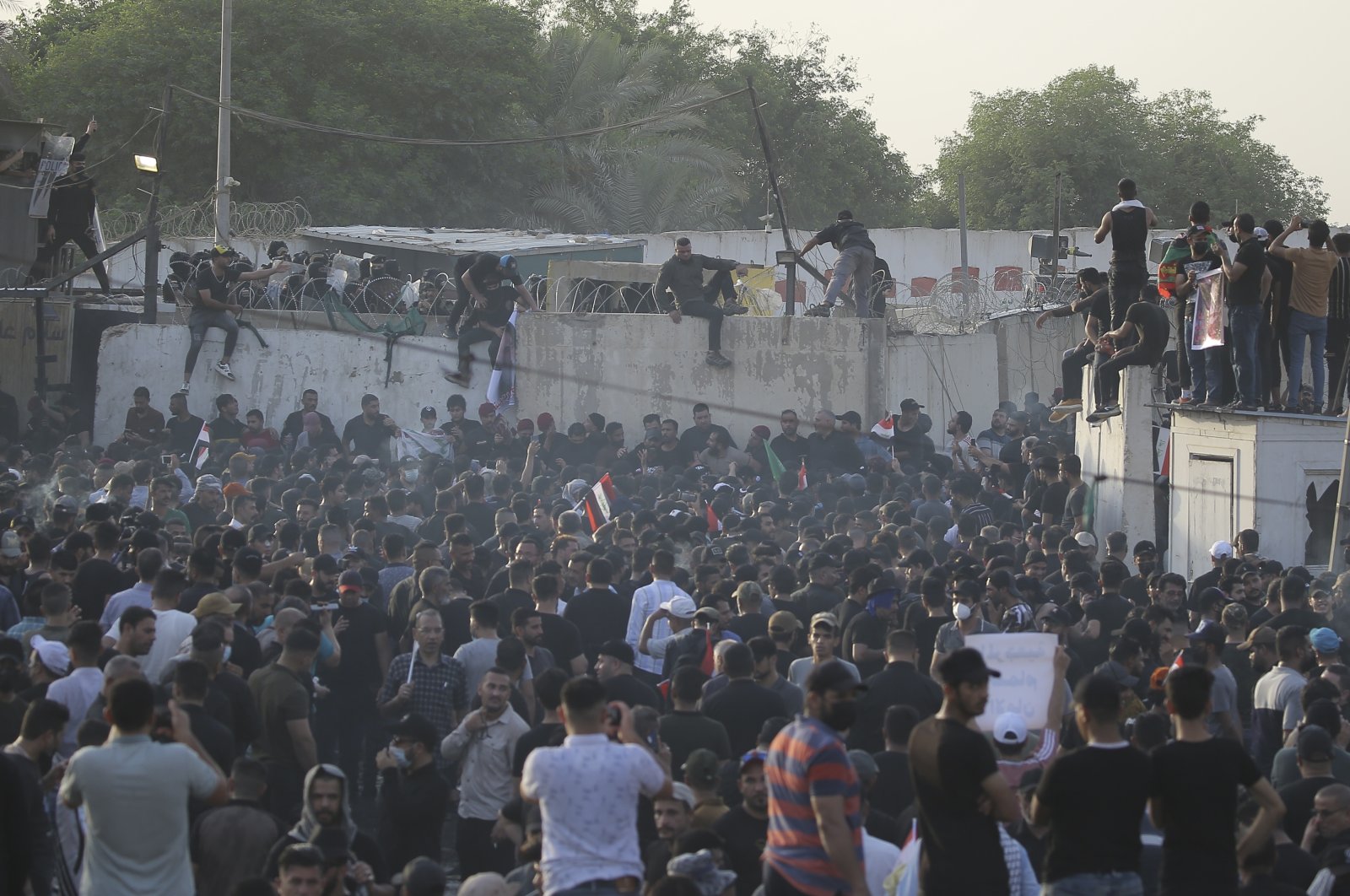 Supporters of a political alliance of Iran-backed groups attempt to storm government areas in the Green Zone in Baghdad, Iraq, Aug. 1, 2022. (AP Photo)